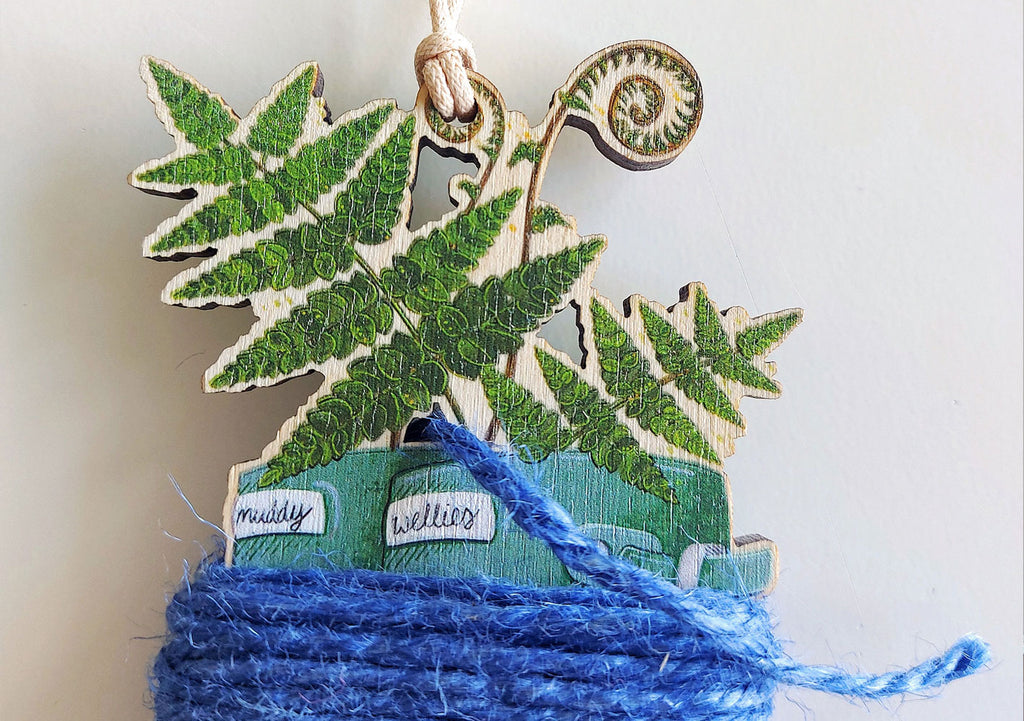 top of green wellington boots with ferns ornament with blue string 